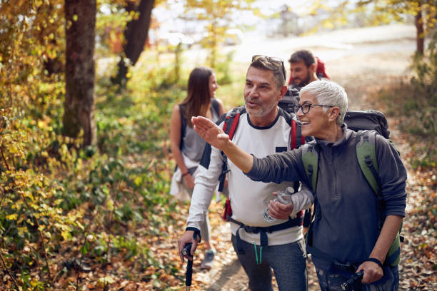 An elderly couple at hiking looking for the trail