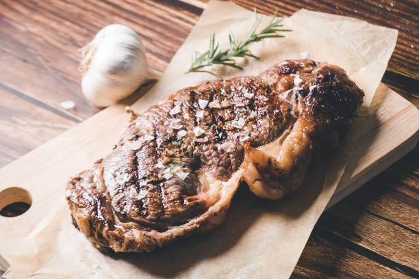 istock Barbecue Aged Roast Beef on wood background 1281426626