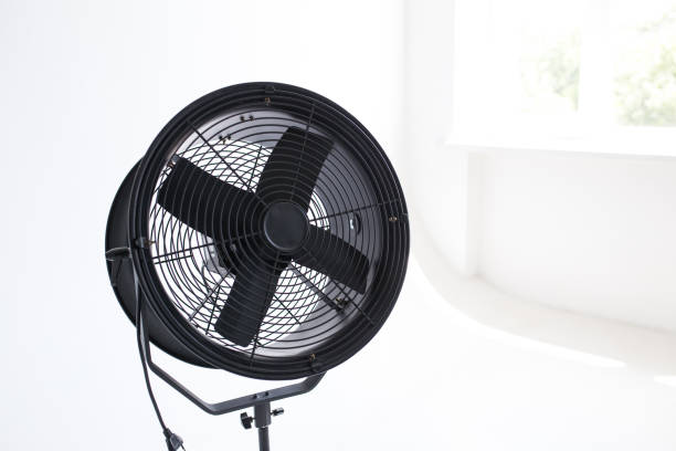 istock Black powerful fan in the white room. Studio isolated 1281426663