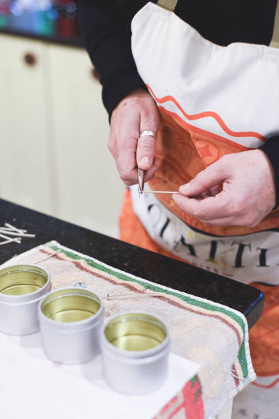 istock A Chandler or candle maker adds a wick to scented hand made candles 1281426788