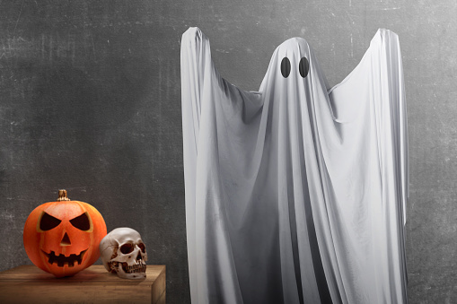 White ghost haunting with black wall background. Halloween concept