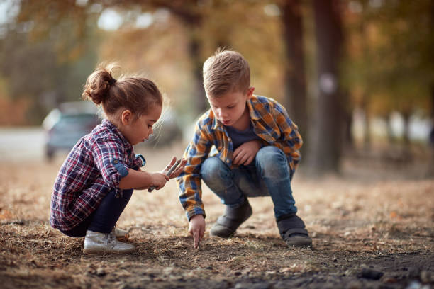istock Kids study the ground in the forest 1281426878