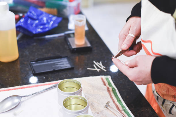 istock A Chandler or candle maker adds a wick to scented hand made candles 1281427201
