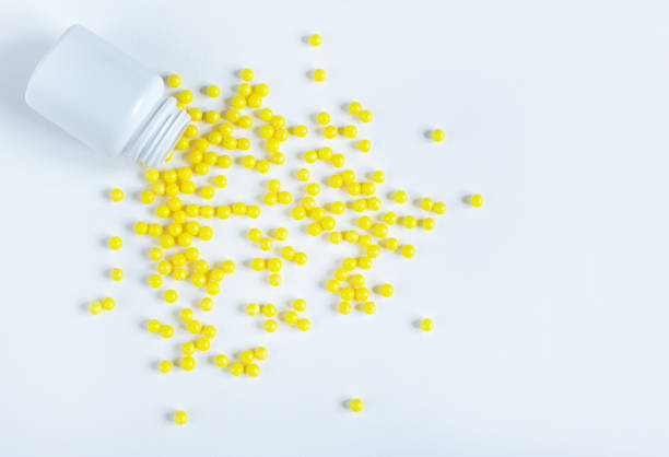 istock Round yellow vitamin C tablets on a white background. 1281429754