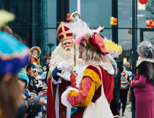 Sinterklaas arriving in Amsterdam November 24, 2018 - Amsterdam, Holland, the Netherlands, Sinterklaas and his "zwarte pieten" arrive in Amsterdam from Spain making many kids happy with handing out sweets zwarte piet stock pictures, royalty-free photos & images