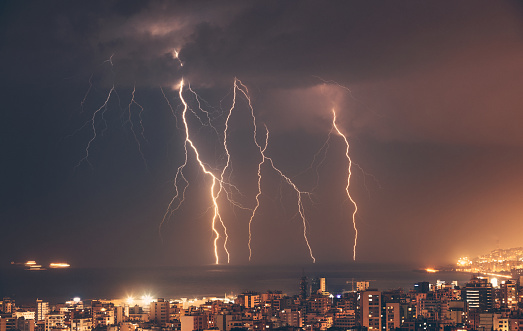 Beautiful lightning over night city, amazing cityscape with many bright zippers over it. Beirut, Lebanon