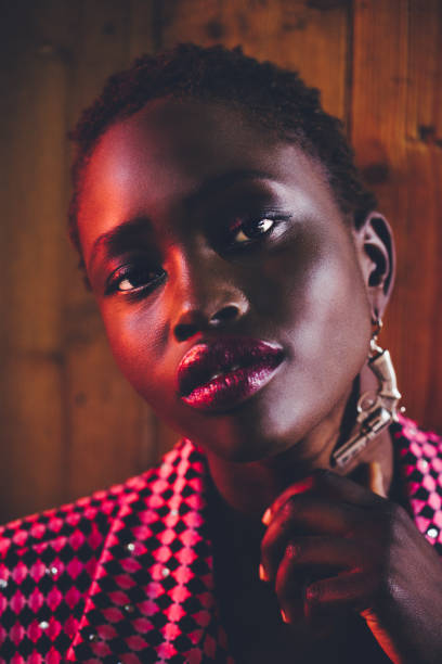 istock Black model with a pretty smile against a wooden background 1281432374