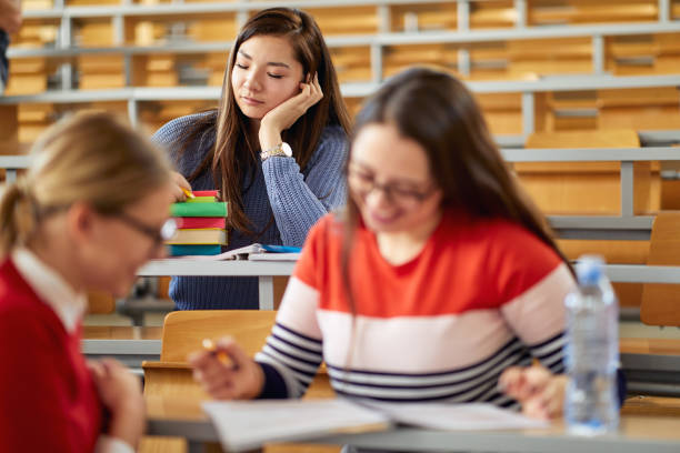 istock Female student taking a nap at the desk at the lecture 1281432618