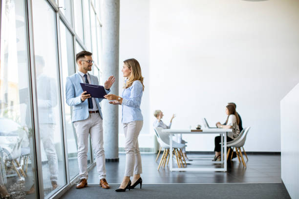 istock Two business people looking a file in a modern office 1281432692
