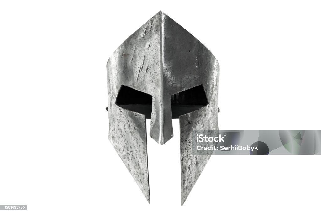 Ancient iron spartan head protection isolated on white. Front view of ancient iron spartan helmet isolated on white studio background. Medieval armor, archeological souvenir from past times, metal tough head protective clothes. Sports Helmet Stock Photo