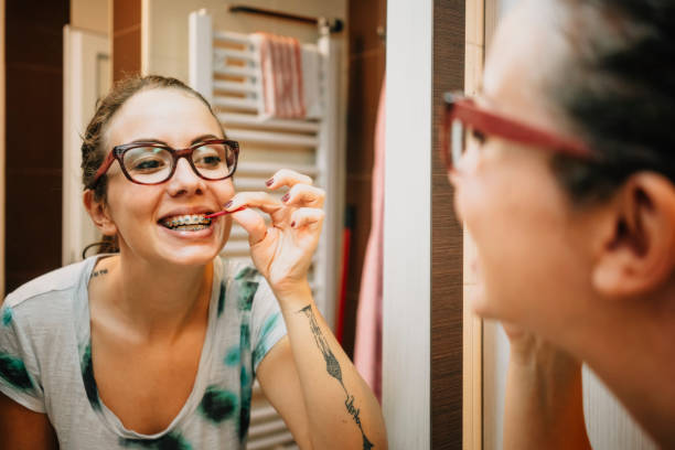 istock Woman cleaning her teeth's with interdental brush 1281434241