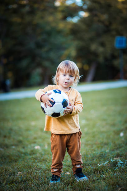 istock Cute little football player. 1281434515