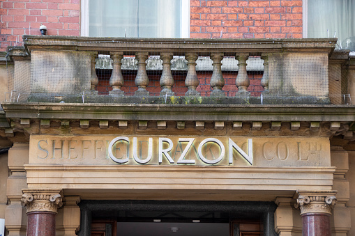 Sheffield,  UK - 30 Nov 2018 : Curzon Theatre metal sign above original Sheffield Bank carved lettering at 16 George Street