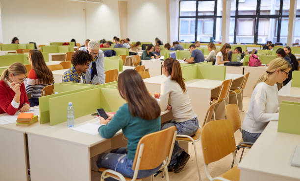 istock Students at a lecture in an educational institution. Smart young people study at the college. Education, college, university, learning and multiethnic people concept 1281435171