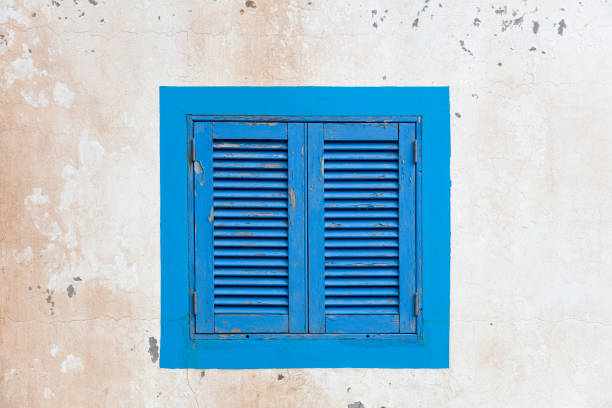 istock Vintage blue window shutter on the old house 1281435604