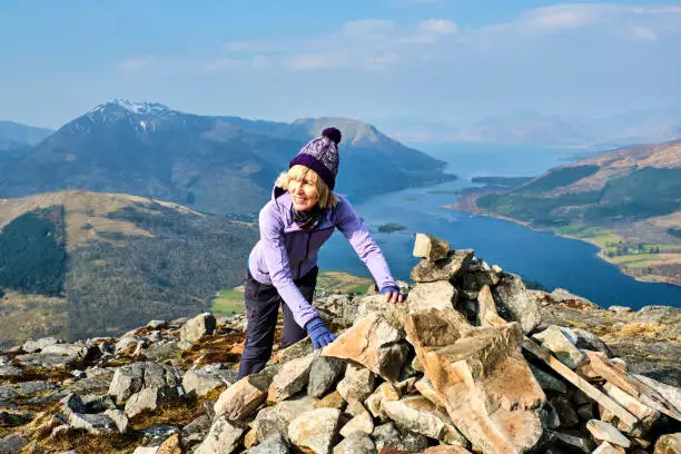 Mature adult at the summit of the Pap of Glencoe, Scotland.