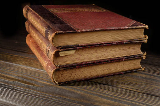 istock A stack of old books lying on a wooden table 1281436869