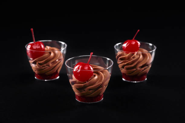 istock Glasses with jam, whipped chocolate cream and cherries. 1281437038