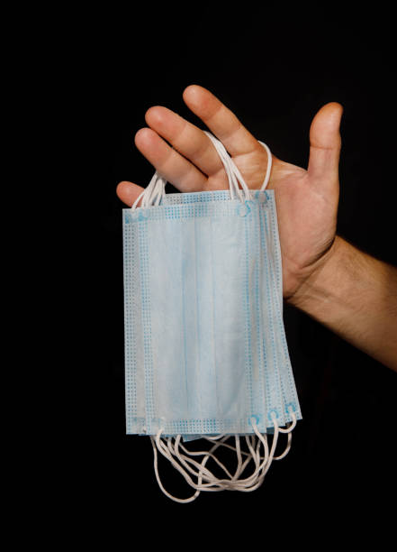 istock male hand holding several disposable medical masks 1281437194