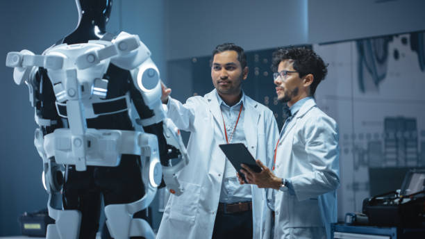 istock In Robotics Development Laboratory International Team of Engineers and Scientists Work on Robotics Exoskeleton Prototype. Designing Powered Exosuit to Help Disabled People Walk, Workers to Lift Goods 1281439943