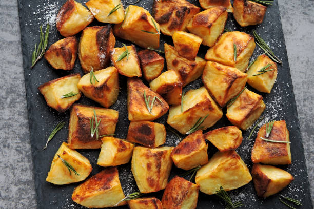 istock Baked potato pieces. Potatoes in a rustic style. 1281440130