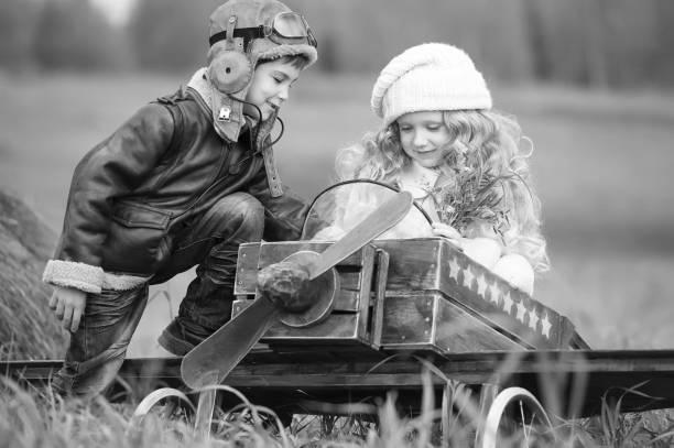 istock Children with a model airplane field 1281440334