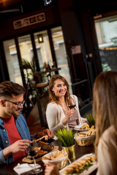 istock Group of young people having dinner in the restaurant 1281442889
