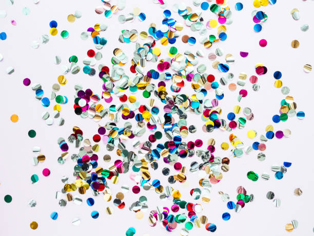 istock Multi-colored shiny round confetti on a pink background, top view, copy space, flat lay 1281443321