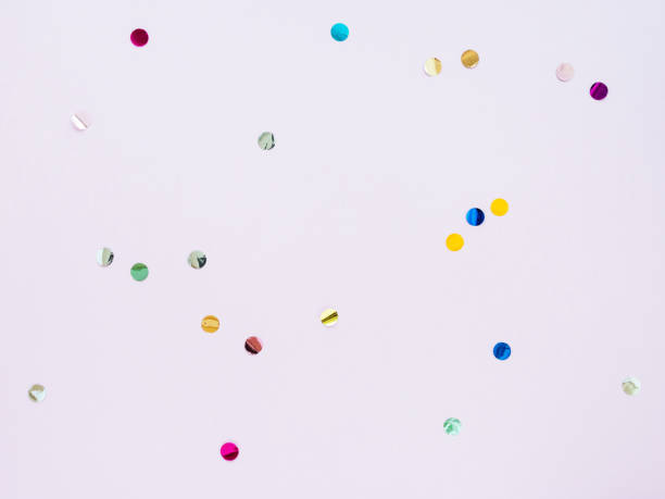 istock Multi-colored shiny round confetti on a pink background, top view, copy space, flat lay 1281443325