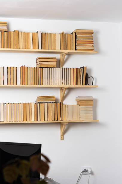 istock Bookshelves with hardback overturned books 1281444426