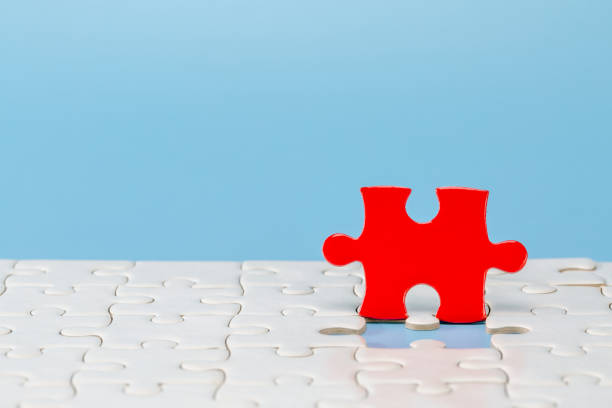 istock Blue background made from red and white  puzzle pieces and place for your content. 1281445600