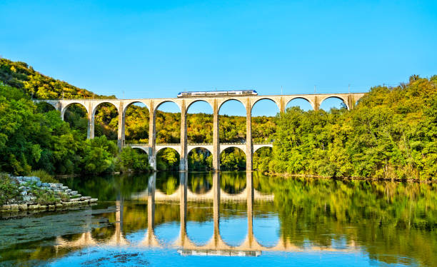 Regional train on the Cize-Bolozon viaduct in France stock photo