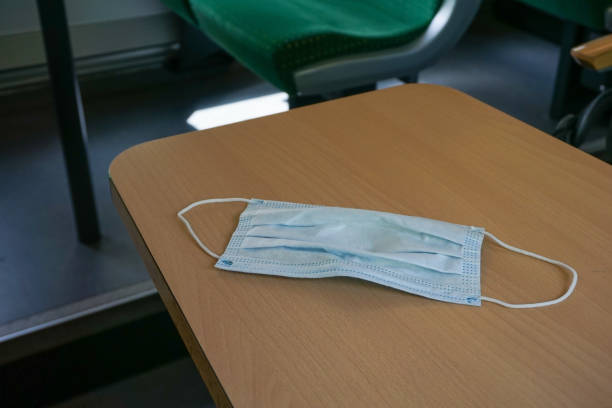 istock Surgical face mask on a table in the public transport 1281448478