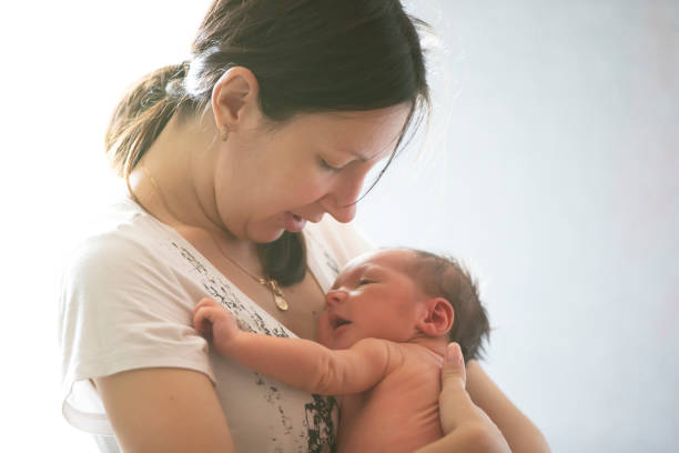 istock A young mother holds a newborn baby in her arms. 1281449708