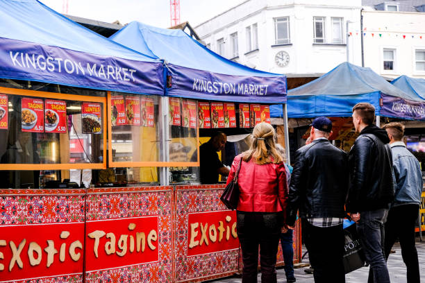 people queuing at an exotic spicy tagine pop-up food stall - tangine imagens e fotografias de stock