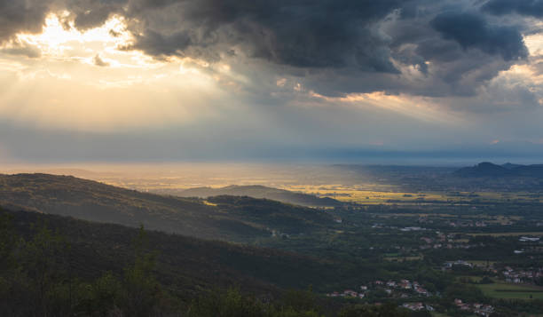 istock Stormy Clouds Sunshine Hole on Landscape from Drone View 1281451631