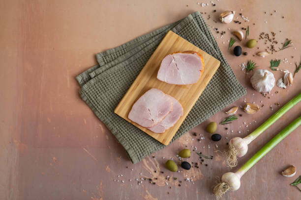 istock Smoked pork ham in one piece and cut into slices 1281452722