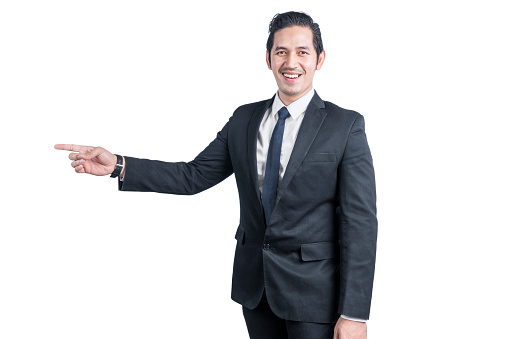 Asian businessman pointing something isolated over white background