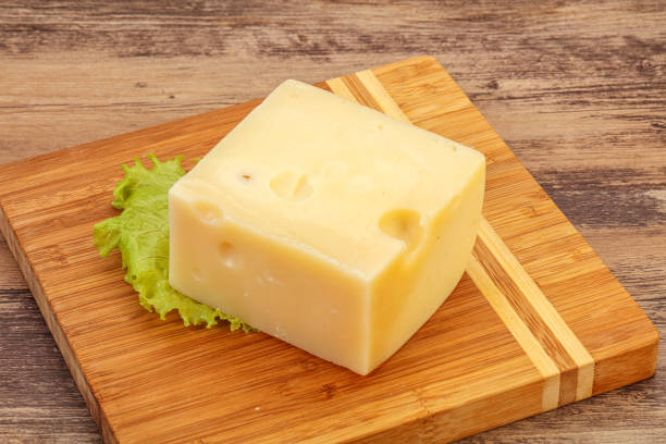 istock Emmental cheese over wooden board 1281453337