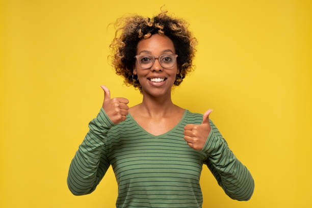 istock Smiling black woman giving thumbs up gesture 1281453681