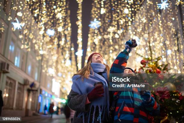 Mother And Son At A Christmas Market Stock Photo - Download Image Now - Christmas, Christmas Lights, Family