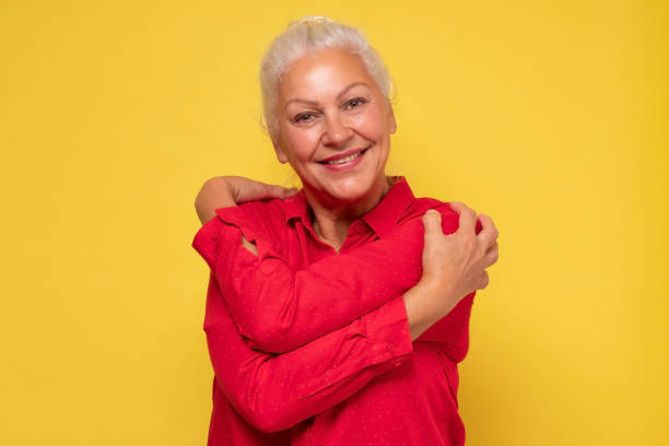 istock Woman wearing red clothes hugging herself being positive, smiling confident. 1281455599