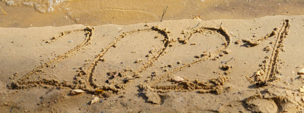 istock 2021. Written at the sandy beach 1281456933