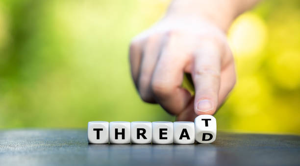 istock Symbol for online hate. Hand turns dice and changes the word 