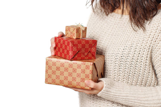 istock Young woman with Gift boxes in hands isolated on white close up 1281458180