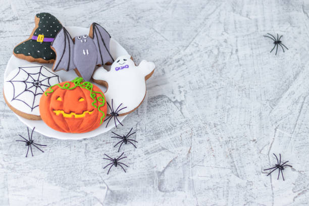 istock delicious halloween cookies on white textured concrete. Copy space. Soft focus 1281461226