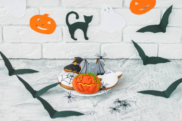 istock delicious halloween cookies on white textured concrete. Soft focus 1281461235
