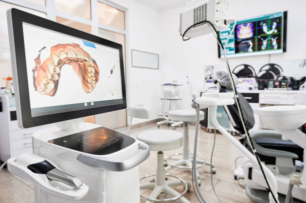 Dental intraoral scanner in modern clinic. Interior of dental office with modern equipment and dental intraoral scanner with teeth on display, medical system for intraoral scanning. Concept of digital dentistry and dental scanning technology. orthodontist photos stock pictures, royalty-free photos & images