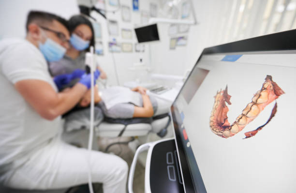 Modern high precision technologies in dentistry Dentist scanning patient's teeth with modern scanning machine. Digital print of patient's teeth is on big screen. Modern high precision technologies. Concept of modern dentistry 3d scanning photos stock pictures, royalty-free photos & images