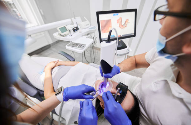 istock Doctor scanning patient mouth with modern intraoral scanner. 1281462820